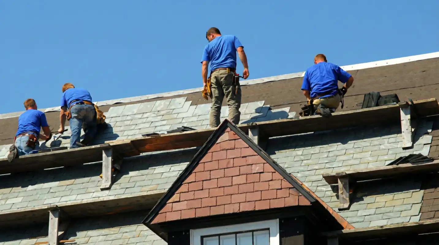 Roof replacement in progress with a team of professional contractors installing new shingles on a residential home in Aurora, CO
