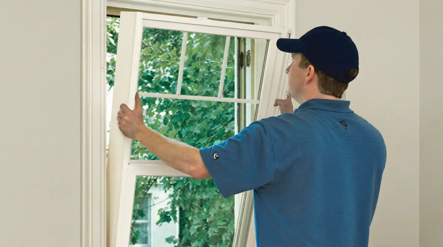 Professional contractors performing a residential window insulation and replacement service in Aurora, CO